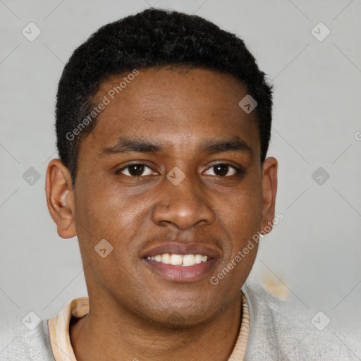 Joyful black young-adult male with short  brown hair and brown eyes