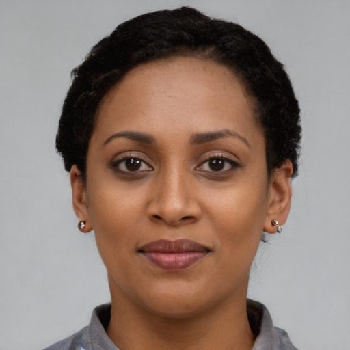 Joyful latino young-adult female with short  black hair and brown eyes