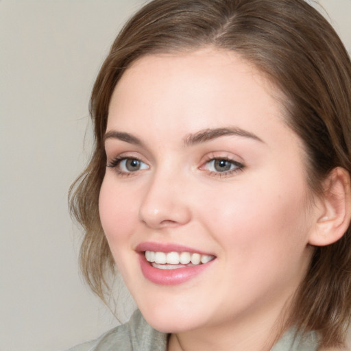 Joyful white young-adult female with medium  brown hair and blue eyes