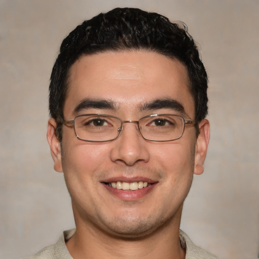 Joyful white young-adult male with short  black hair and brown eyes