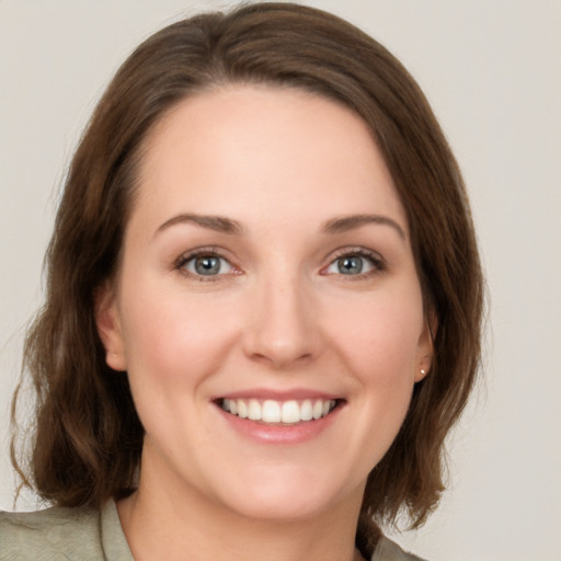 Joyful white young-adult female with medium  brown hair and green eyes