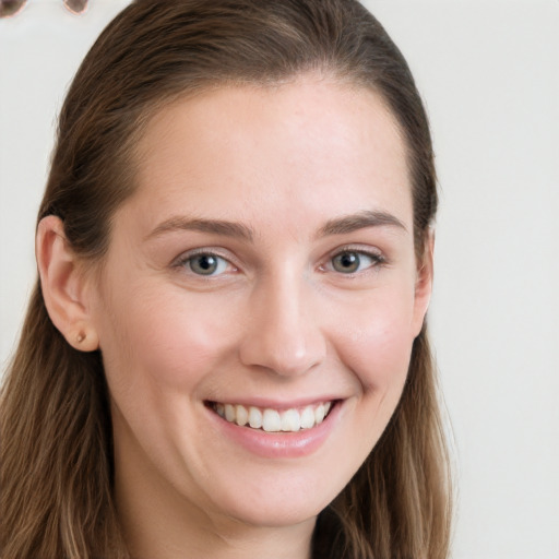 Joyful white young-adult female with long  brown hair and grey eyes