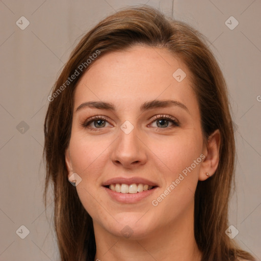 Joyful white young-adult female with long  brown hair and green eyes