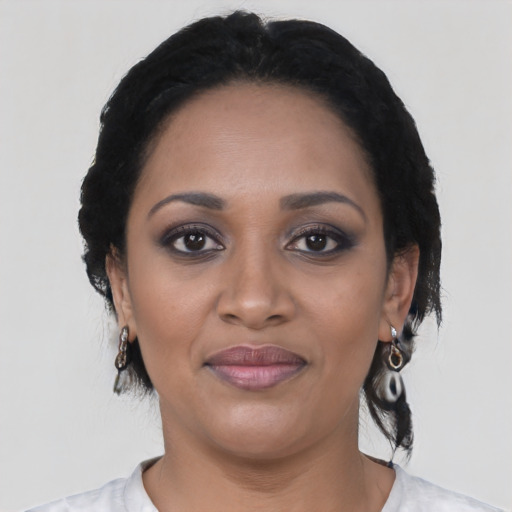 Joyful black young-adult female with medium  black hair and brown eyes