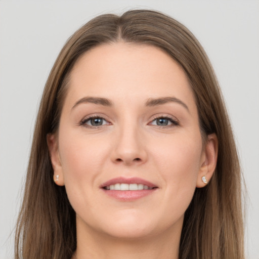 Joyful white young-adult female with long  brown hair and grey eyes