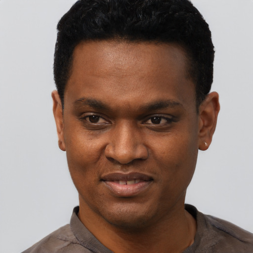 Joyful black young-adult male with short  black hair and brown eyes