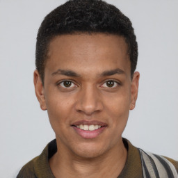 Joyful black young-adult male with short  brown hair and brown eyes