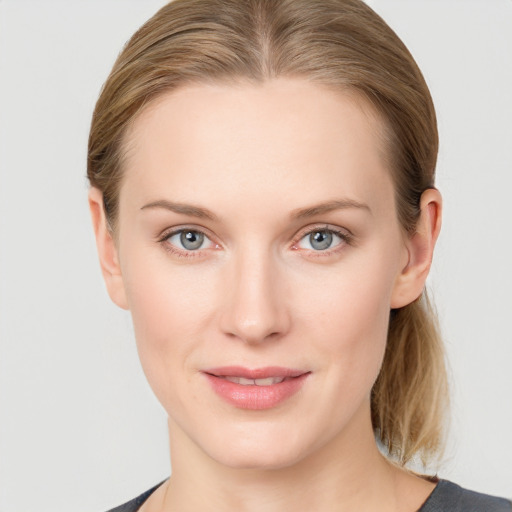 Joyful white young-adult female with medium  brown hair and blue eyes