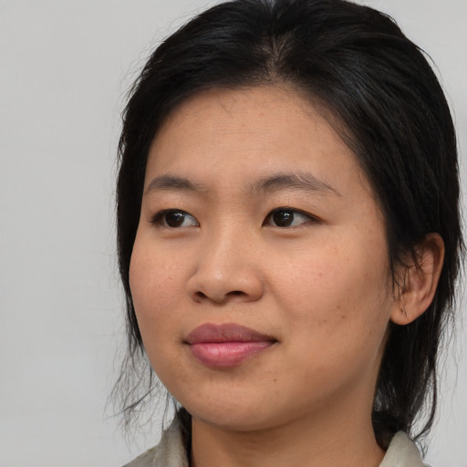Joyful asian young-adult female with medium  brown hair and brown eyes