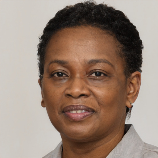Joyful black adult female with short  brown hair and brown eyes