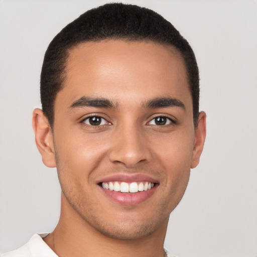 Joyful latino young-adult male with short  brown hair and brown eyes