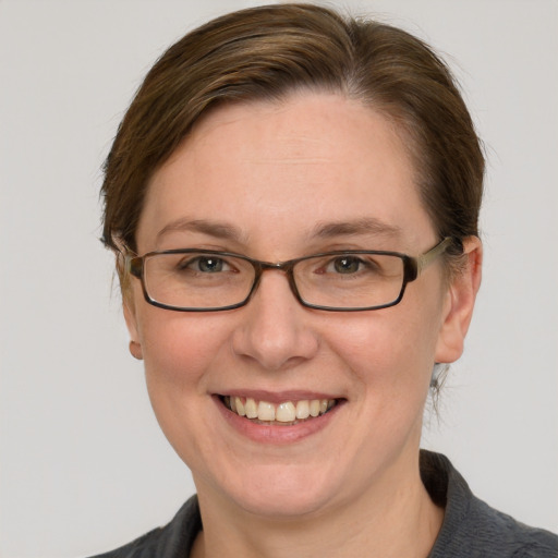 Joyful white adult female with short  brown hair and grey eyes