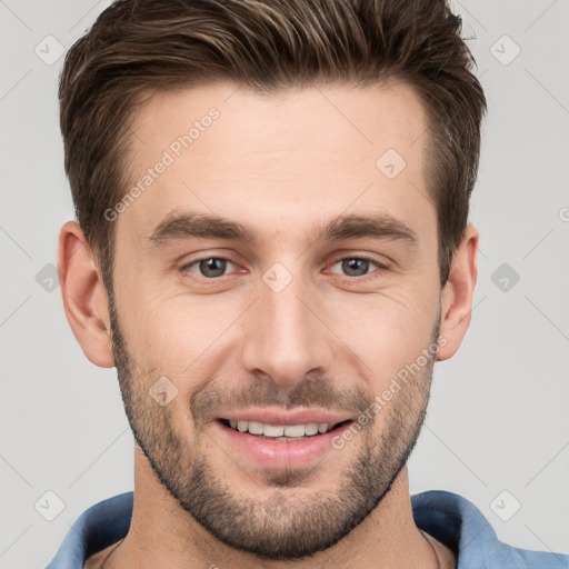 Joyful white young-adult male with short  brown hair and grey eyes