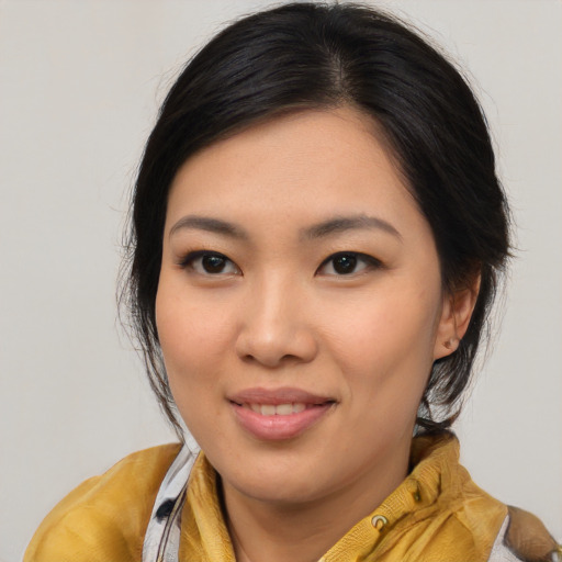 Joyful asian young-adult female with medium  brown hair and brown eyes