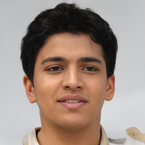 Joyful latino young-adult male with short  brown hair and brown eyes