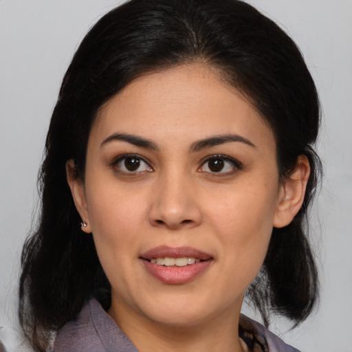 Joyful latino young-adult female with medium  brown hair and brown eyes