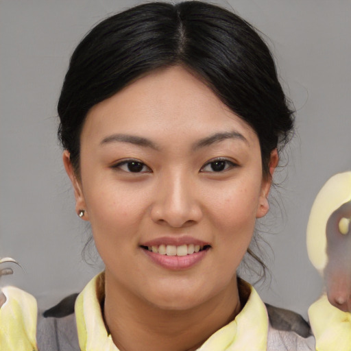 Joyful asian young-adult female with medium  brown hair and brown eyes