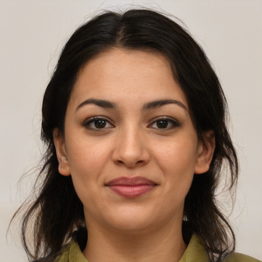 Joyful latino young-adult female with medium  brown hair and brown eyes