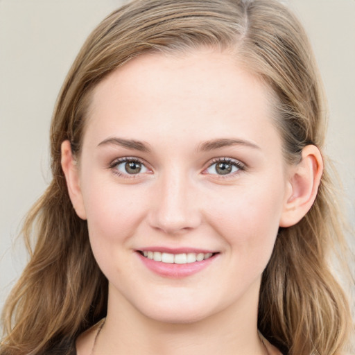 Joyful white young-adult female with long  brown hair and blue eyes