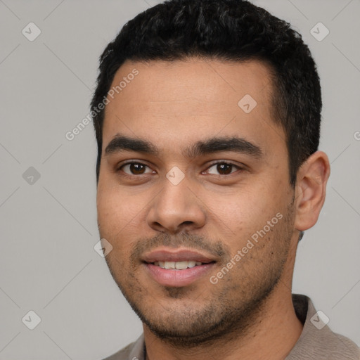 Joyful latino young-adult male with short  black hair and brown eyes