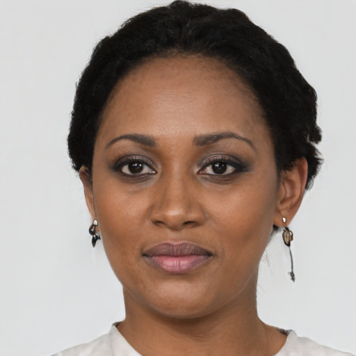 Joyful black adult female with short  black hair and brown eyes