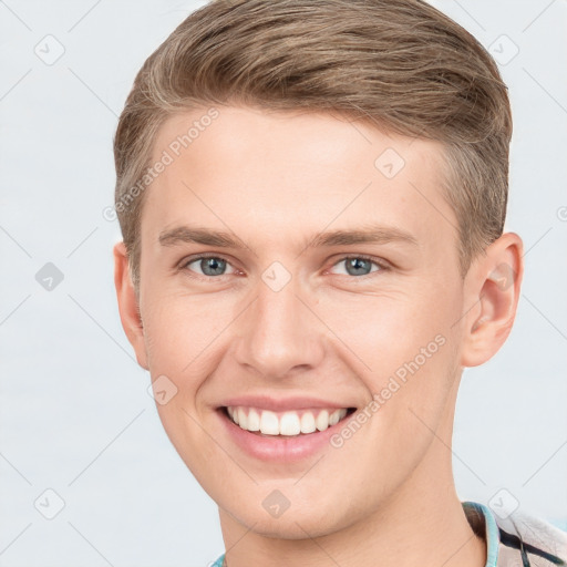 Joyful white young-adult male with short  brown hair and grey eyes