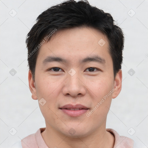 Joyful asian young-adult male with short  brown hair and brown eyes