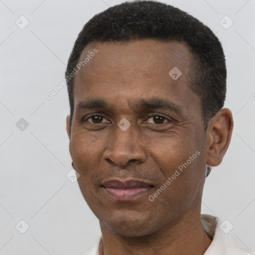 Joyful black adult male with short  black hair and brown eyes