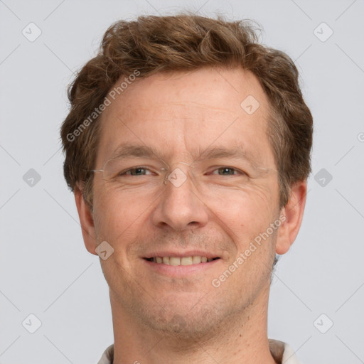 Joyful white adult male with short  brown hair and grey eyes