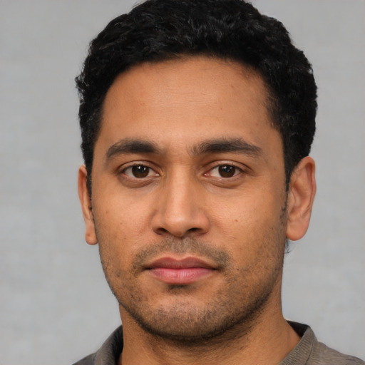 Neutral latino young-adult male with short  black hair and brown eyes