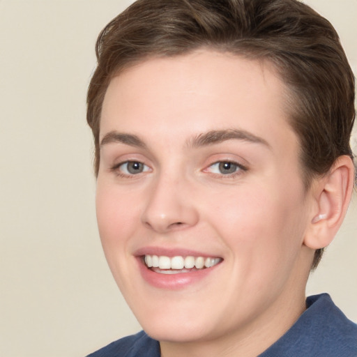 Joyful white young-adult female with short  brown hair and grey eyes