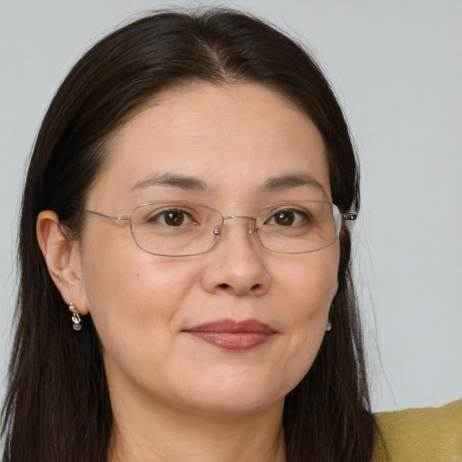 Joyful white adult female with long  brown hair and brown eyes