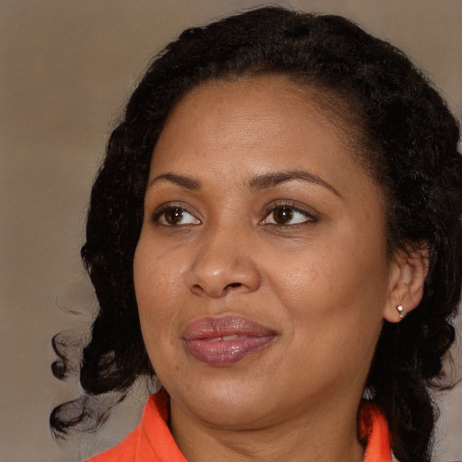 Joyful black adult female with medium  brown hair and brown eyes