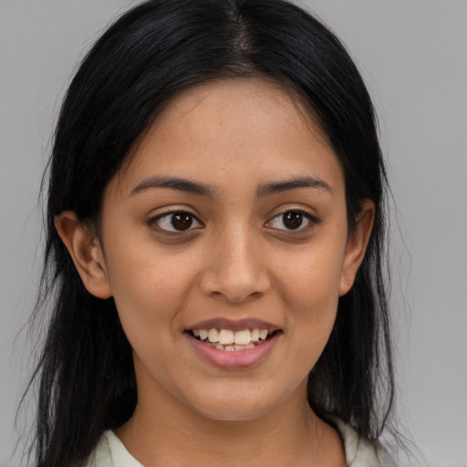 Joyful latino young-adult female with long  black hair and brown eyes