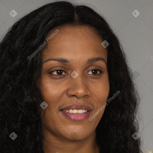 Joyful black young-adult female with long  brown hair and brown eyes