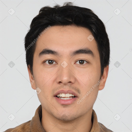 Joyful asian young-adult male with short  black hair and brown eyes