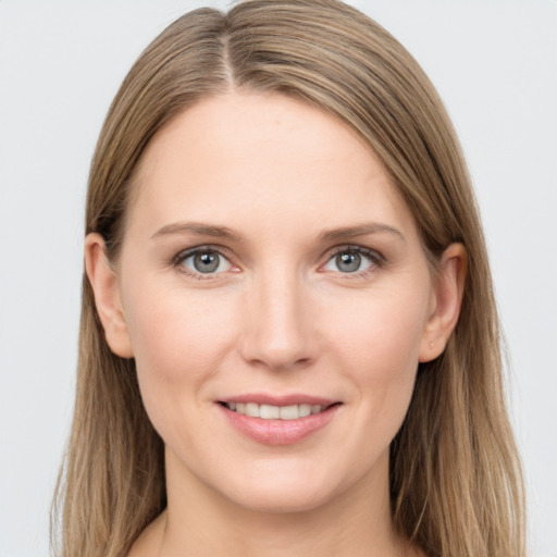 Joyful white young-adult female with long  brown hair and grey eyes