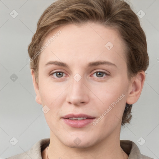 Joyful white young-adult female with short  brown hair and grey eyes