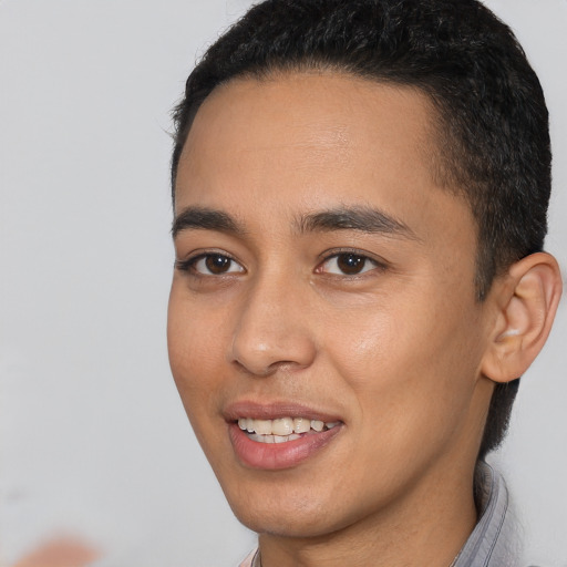 Joyful latino young-adult male with short  brown hair and brown eyes