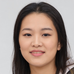 Joyful asian young-adult female with long  brown hair and brown eyes