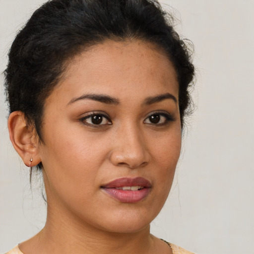 Joyful latino young-adult female with short  brown hair and brown eyes