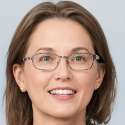 Joyful white adult female with medium  brown hair and grey eyes