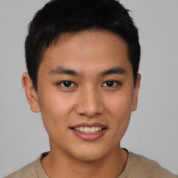 Joyful asian young-adult male with short  brown hair and brown eyes