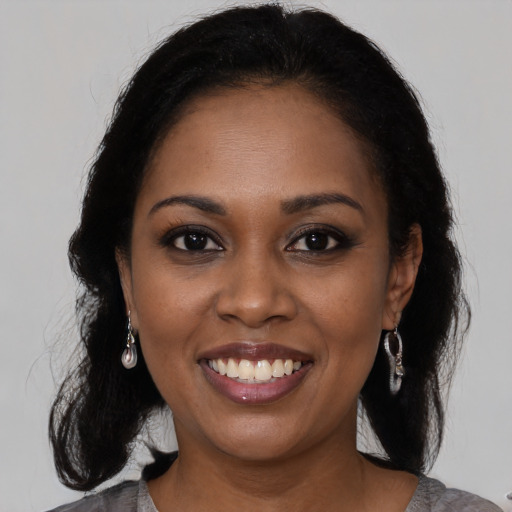 Joyful black young-adult female with medium  black hair and brown eyes
