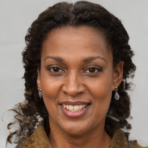 Joyful black adult female with medium  brown hair and brown eyes