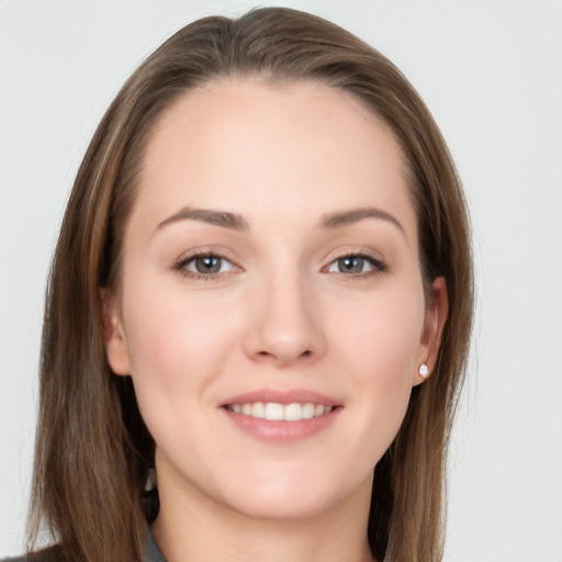 Joyful white young-adult female with long  brown hair and grey eyes