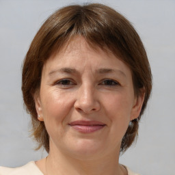 Joyful white adult female with medium  brown hair and brown eyes