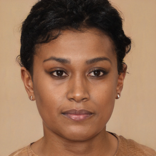Joyful black young-adult female with short  brown hair and brown eyes
