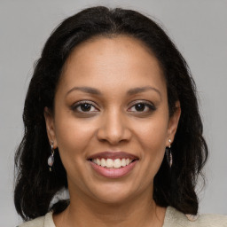 Joyful latino young-adult female with medium  brown hair and brown eyes