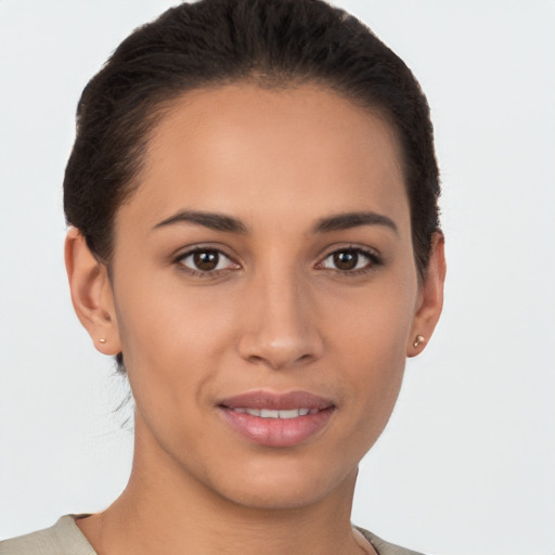 Joyful latino young-adult female with short  brown hair and brown eyes